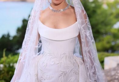 Maya Reaidy captivated the world on her wedding day in Greece, making a grand entrance at Athens’ Olympic Stadium in a breathtaking custom bridal gown by GEORGES HOBEIKA. The former Miss Lebanon’s dress embodied the Maison’s renowned craftsmanship, merging a sculptural elegance with a dreamlike, enchanting aesthetic.Drawing inspiration from 18th-century fashion, the gown’s majestic silhouette harmonized with the bride’s personality and the grandeur of the surroundings. The meticulous artisanship brought the luxurious fabrics to life, with a skillful interplay of contrasts and volumes.The design featured a crystal-studded tulle overskirt that added an aura of mystery and light to the mermaid-style dress, while a strapless bodice in double silk crepe was delicately embroidered with matte silk threads. The intricate silk thread embroidery continued onto the sparkling veil, enhancing the gown’s ethereal allure.Crafted by eleven skilled artisans, the gown required 714 hours of meticulous work, resulting in a truly unique and mesmerizing creation fit for a fairytale wedding!Congratulations@mayareaidy@georgeshobeika @jadhobeika@patricksawaya#mayareaidy #bridal #georgeshobeika #fashioninspo