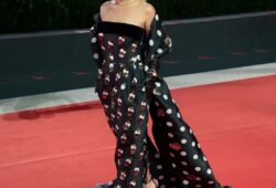 Brazilian model and influencer Maria Braz captivated the crowd at the Venice Film Festival, making a striking appearance at the screening of ‘The Room Next Door.’ She dazzled in a stunning creation by Lebanese designer Georges Chakra—a strapless gown that artfully combined bold polka dots with intricate sequin embellishments. Elevating the look to new heights, Braz draped a dramatic, oversized polka-dotted shawl over her arms, exuding both elegance and avant-garde flair. It was a moment of pure sartorial brilliance that left a lasting impression on the red carpet.